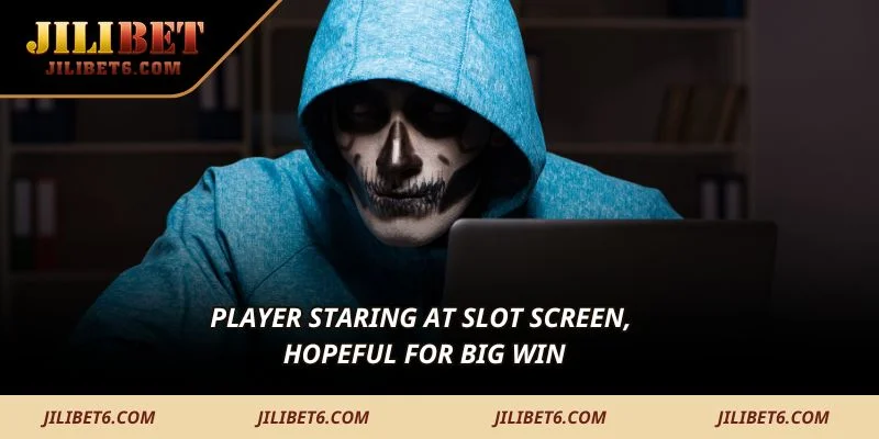 Player staring at slot screen, hopeful for big win